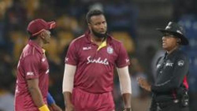 West Indies' captain Kieron Pollard , second right, speaks with umpire (AP) West Indies' captain Kieron Pollard , second right, speaks with umpire (AP)