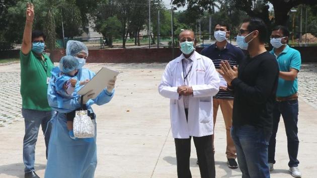 The infant who recovered from Covid, in her mother’s arms, being discharged from PGIMER, Chandigarh on Sunday.