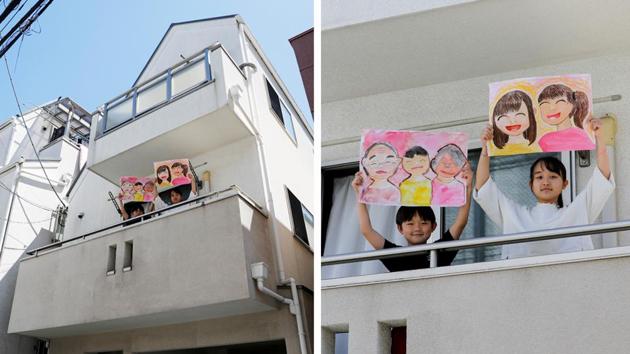 Reku Matsui, 8, and Yaya Matsui, 12, hold pictures that they drew, standing on the balcony of their home in Tokyo, Japan. “I miss being with my grandmother and my grandfather. Also, I want to go to my grandmother’s house,” Reku told Reuters, who drew a picture of himself standing in between his two smiling grandparents. Yaya drew a picture of herself and a friend. (Kim Kyung-Hoon / REUTERS) Reku Matsui, 8, and Yaya Matsui, 12, hold pictures that they drew, standing on the balcony of their home in Tokyo, Japan. “I miss being with my grandmother and my grandfather. Also, I want to go to my grandmother’s house,” Reku told Reuters, who drew a picture of himself standing in between his two smiling grandparents. Yaya drew a picture of herself and a friend. (Kim Kyung-Hoon / REUTERS)