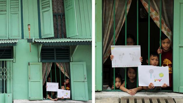 Maryem Abdul Hadi, 11, and Abbaas Abdul Hadi, 7, hold pictures that they drew, as they stand by a window with their siblings Faathimah Abdul Hadi, 3, Shofiyyah Abdul Hadi, 5, and Muhammad Abdul Hadi, 10, in Kuala Lumpur, Malaysia. “I drew myself playing with my friends,” Maryem told Reuters. “I miss playing with my friends.” (Lim Huey Teng / REUTERS) Maryem Abdul Hadi, 11, and Abbaas Abdul Hadi, 7, hold pictures that they drew, as they stand by a window with their siblings Faathimah Abdul Hadi, 3, Shofiyyah Abdul Hadi, 5, and Muhammad Abdul Hadi, 10, in Kuala Lumpur, Malaysia. “I drew myself playing with my friends,” Maryem told Reuters. “I miss playing with my friends.” (Lim Huey Teng / REUTERS)