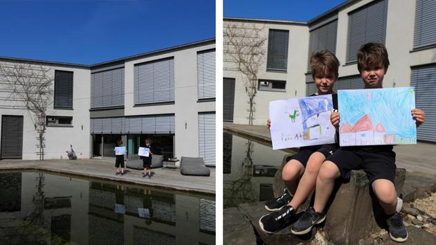 Noa, 7, and Tom, 6, hold pictures that they drew as they sit in front of their house in Bad Honnef, Germany. “I painted the school and my friend Moritz because I am missing him so much as well as the Odyseeum because I miss it,” Noa told Reuters. Tom said: “I have painted a picture of the house of grandma and grandpa because I miss them so much.” (Wolfgang Rattay / REUTERS) Noa, 7, and Tom, 6, hold pictures that they drew as they sit in front of their house in Bad Honnef, Germany. “I painted the school and my friend Moritz because I am missing him so much as well as the Odyseeum because I miss it,” Noa told Reuters. Tom said: “I have painted a picture of the house of grandma and grandpa because I miss them so much.” (Wolfgang Rattay / REUTERS)