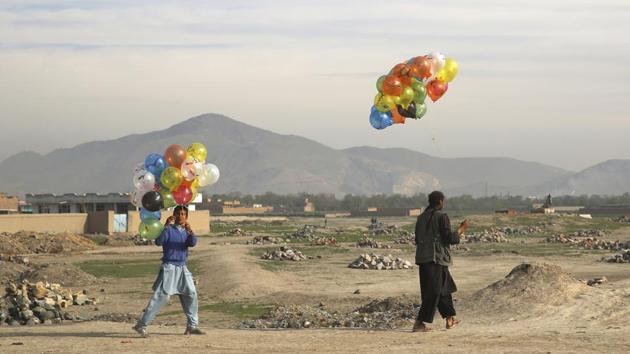 Vendors walk with colored balloons for sale on the outskirts of Kabul, Afghanistan, Wednesday, April 22, 2020.(AP)