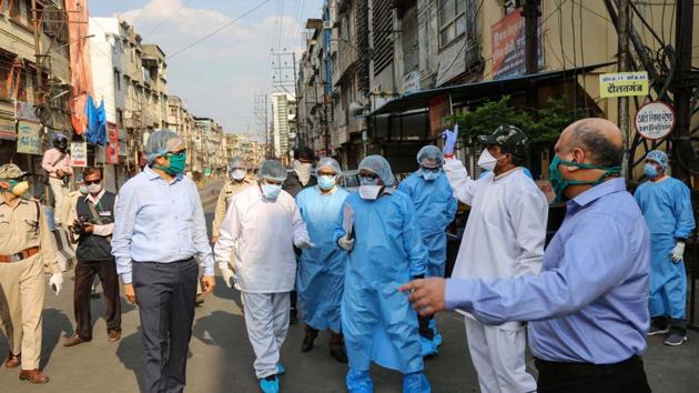 Indore divisional commissioner Akash Tripathi along with senior officials inspects Taat Patti Bakhal area where health workers were attacked by some locals who went there to screen residents in wake of COVID 19 pandemic, in Indore.(PTI)
