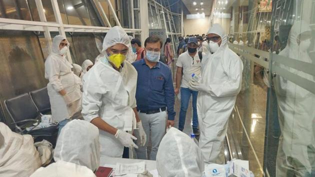 Health officials screen passengers arriving from Dubai before being sent to hospital in the wake of coronavirus pandemic, in Indore. (PTI) Health officials screen passengers arriving from Dubai before being sent to hospital in the wake of coronavirus pandemic, in Indore. (PTI)