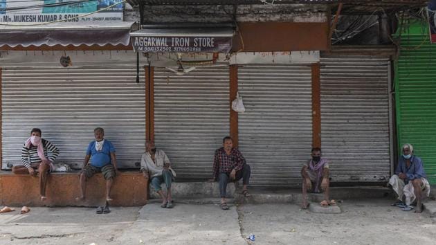 Migrant labourers resting in a lane in Sadar Bazar, during lockdown in New Delhi, India, on Saturday, April 25, 2020. (Sanchit Khanna/HT PHOTO) Migrant labourers resting in a lane in Sadar Bazar, during lockdown in New Delhi, India, on Saturday, April 25, 2020. (Sanchit Khanna/HT PHOTO)