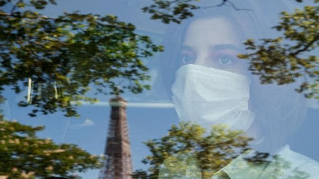 Yara Al-Hasbani, 27-year-old, a Syrian dancer and choreographer looks through the window of a car reflecting the Eiffel tower in Paris, on the 37th day of a strict lockdown in France to stop the spread of COVID-19 (novel coronavirus), on April 22. She first arrived in Rochefort, a scenic port town in the southwest of France, and then moved to Paris in 2016, a city where she found it difficult to settle at first. (Sameer Al-DOUMY / AFP)