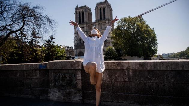 Syrian dancer and choreographer Yara al-Hasbani performs in front of the Notre Dame cathedral in Paris . Her first visit to the famous Palais Garnier theatre opened the emotional floodgates and made her create the performance "Unstoppable," a 12-minute solo retracing her journey to exile. (Sameer Al-DOUMY / AFP)