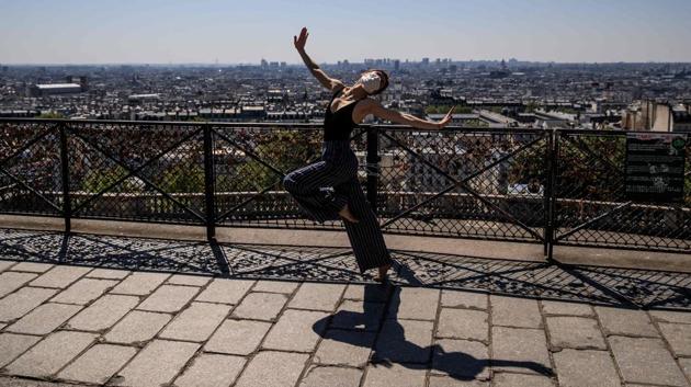 Yara al-Hasbani performs in Montmartre with Paris in the background. Her dance may be silent, she said once, but she'll carry on "raising her voice so people don't forget." (Sameer Al-DOUMY / AFP)