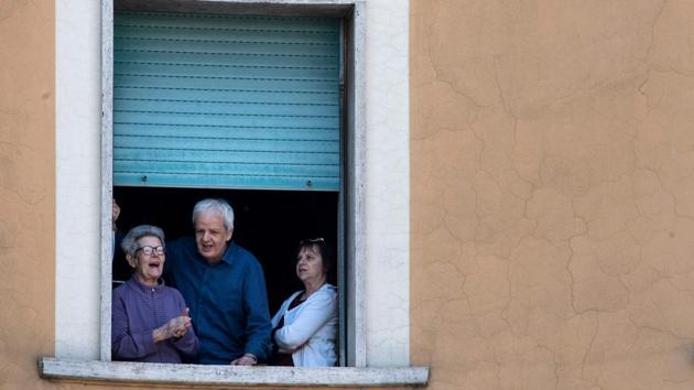 Residents in the Garbatella district of Rome sing as part of a 'Liberation Day' flashmob on April 25. The day’s big invent involved everyone joining a singalong from their windows of “Bella Ciao” -- an old protest song that turned into Italy’s unofficial anti-Fascist anthem. (Tiziana Fabi / AFP)
