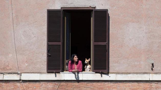 A resident and her dog in the Garbatella district of Rome on April 25. Liberation Day marks Italy’s freedom from the Nazi-Fascist occupation of World War II in 1945. (Tiziana Fabi / AFP)