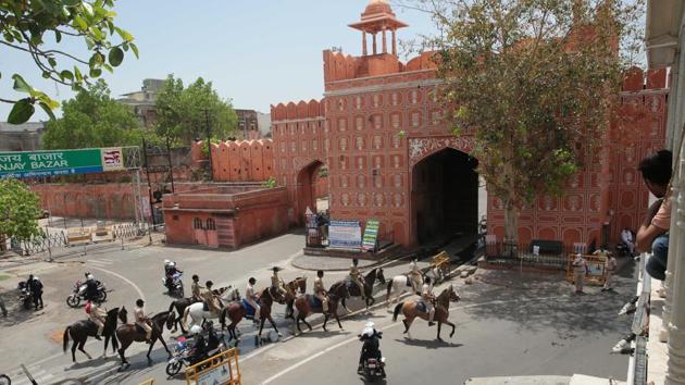 Police personnel on horseback during a flag march to announce lockdown and restrictions on movement in the walled city area of Jaipur, Rajasthan on Saturday.(Himanshu Vyas/HT Photo)