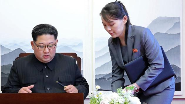 North Korean leader Kim Jong Un signs a guestbook next to his sister Kim Yo Jong.(AP photo)