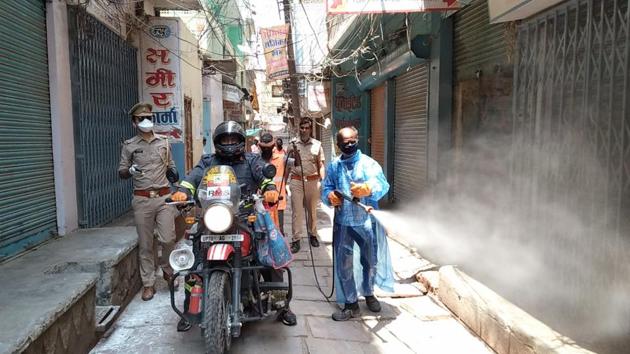 Municipal workers spray disinfectant in an area in Uttar Pradesh’ Varanasi, during the Covid-19 lockdown, on Saturday.(ANI Phoro)