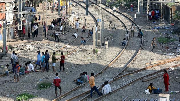 People from nearby slums sitting on railway tracks atMumbai’s Matunga railway station on Sunday to pass their time during the lockdown. (ANI) People from nearby slums sitting on railway tracks atMumbai’s Matunga railway station on Sunday to pass their time during the lockdown. (ANI)