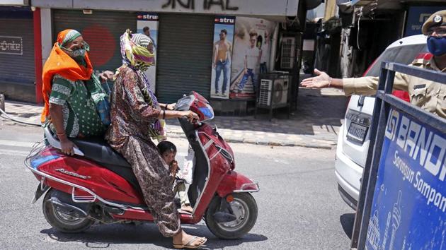 Policeman stop people travelling during nationwide lockdown imposed in wake of the coronavirus outbreak, in Ahmedabad on Saturday. (ANI Photo) Policeman stop people travelling during nationwide lockdown imposed in wake of the coronavirus outbreak, in Ahmedabad on Saturday. (ANI Photo)
