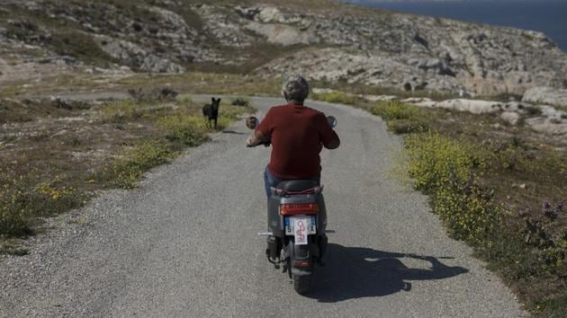 Patrick Tellier rides his scooter towards the port of Frioul. Now retired, he spent his nursing career working in Africa and in Marseille, where he helped set up a medical centre for underprivileged families. (Daniel Cole / AP) Patrick Tellier rides his scooter towards the port of Frioul. Now retired, he spent his nursing career working in Africa and in Marseille, where he helped set up a medical centre for underprivileged families. (Daniel Cole / AP)