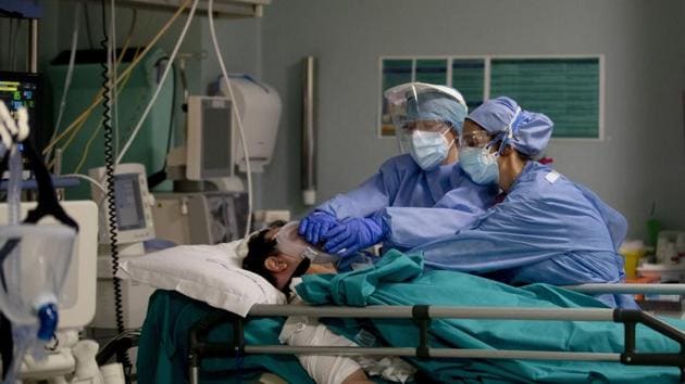 Medical staff tend to a patient in the emergency Covid-19 ward at the San Carlo Hospital in Milan, Italy (AP) Medical staff tend to a patient in the emergency Covid-19 ward at the San Carlo Hospital in Milan, Italy (AP)