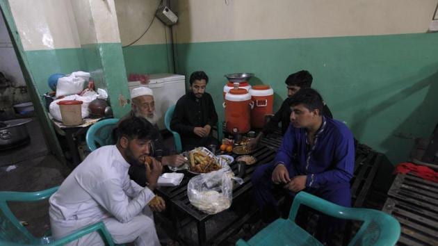 Restaurant workers break their fast on the first day of Ramzan, in Pakistan’s Rawalpindi on Saturday. (AP Photo) Restaurant workers break their fast on the first day of Ramzan, in Pakistan’s Rawalpindi on Saturday. (AP Photo)