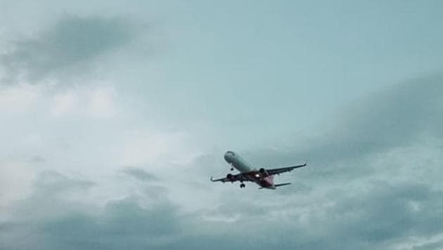 People not travelling together are seated next to each other, many of them toward the rear of the small plane, while several rows of seats toward the front remain empty.(Unsplash)