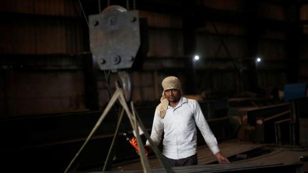 A labourer works at a building material factory in an industrial area in Dasna, in Uttar Pradesh, India.(REUTERS)