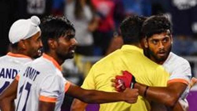 Varun Kumar (C) of India celebrates after scoring a goal during the men's field hockey match between India and England at the 2018 Gold Coast Commonwealth Games on April 11, 2018. (AFP) Varun Kumar (C) of India celebrates after scoring a goal during the men's field hockey match between India and England at the 2018 Gold Coast Commonwealth Games on April 11, 2018. (AFP)