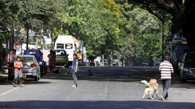 People going to the walk with dogs in the growing concern of Coronavirus outbreak in pune at Gultekdi in Pune, India, on Wednesday, April 8, 2020.(Rahul Raut/HT PHOTO)