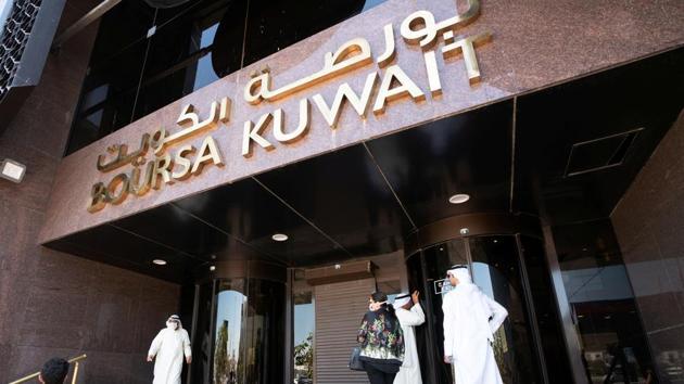 Kuwaiti men look through the glass of the closed doors of the Kuwait Stock Exchange, following the outbreak of coronavirus, in Kuwait City, Kuwait.(REUTERS/ Representative image)