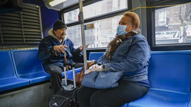A nurse (right) attempts to reason with a fellow bus passenger who refuses to wear a face mask in the wake of Covid-19 pandemic, in upper Manhattan, New York.(AP Photo) A nurse (right) attempts to reason with a fellow bus passenger who refuses to wear a face mask in the wake of Covid-19 pandemic, in upper Manhattan, New York.(AP Photo)