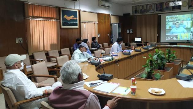 Cabinet ministers Madan Kaushik and Yashpal Arya during a video conference with Union minister Nitin Gadkari on Tuesday.(HT PHOTO)