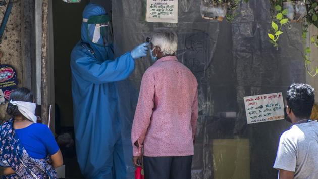 A doctor checks the temperature of patients at Mumbai’s Dharavi, on Monday. (Pratik Chorge/HT Photo) A doctor checks the temperature of patients at Mumbai’s Dharavi, on Monday. (Pratik Chorge/HT Photo)