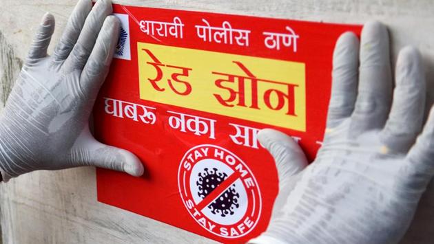 A police personnel pastes a red zone notice declaring the area a containment zone in Dharavi, during the nationwide lockdown against coronavirus in Mumbai. With the state moving close to the 10,000 cases mark, the state government has directed authorities to ensure containments by careful tracing and testing. (Satish Bate / HT Photo) A police personnel pastes a red zone notice declaring the area a containment zone in Dharavi, during the nationwide lockdown against coronavirus in Mumbai. With the state moving close to the 10,000 cases mark, the state government has directed authorities to ensure containments by careful tracing and testing. (Satish Bate / HT Photo)