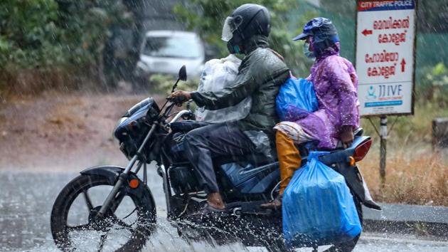 Commuters venture out in heavy rain in Vengeri, Kozhikode, on April 26. The east, north-east and peninsular regions have seen severe thunderstorm activity, typical of the pre-monsoon season. There is a lot of moisture incursion from Bay of Bengal over the east and the north-east, according to K Sathi Devi, head, national weather forecasting centre. (PTI)