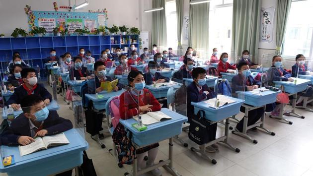 Students in a classroom with partitions on their desks in Chongqing. Inside schools, students were split into classes of about 20 -- smaller than before the epidemic -- while physical education classes stood cancelled. Lunch must be eaten in small groups inside classrooms rather than in the cafeteria, students told AFP. (Cnsphoto via REUTERS)