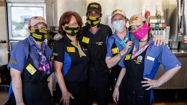 Staff members are pictured at a Waffle House, one of few corporate restaurant chain reopened for in-house dining after a shutdown to prevent the spread of the coronavirus disease in Madison, Georgia, US. (Reuters Photo)