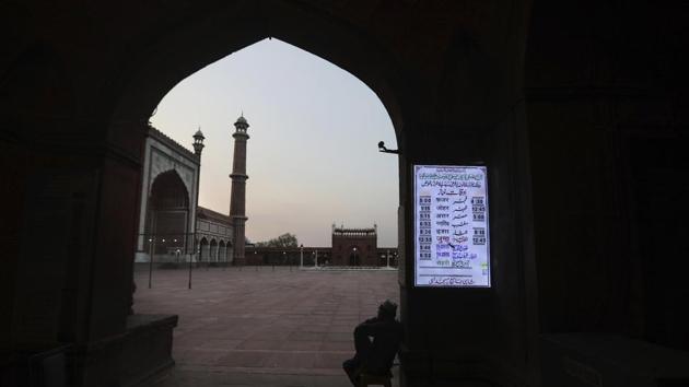 An employee sits at the main gate of deserted Jama Masjid, which is usually packed with thousands of devotees in the holy month of Ramadan, during a nation wide lockdown in place to check the spread of the new coronavirus, in New Delhi. (AP) An employee sits at the main gate of deserted Jama Masjid, which is usually packed with thousands of devotees in the holy month of Ramadan, during a nation wide lockdown in place to check the spread of the new coronavirus, in New Delhi. (AP)