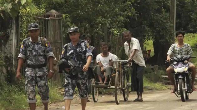 Myanmar Border Guard Police walk ahead of a trishaw driver and passenger along the main road of Buthidaung, northern Rakhine state of Myanmar, on September 6, 2017. (AP file photo for representation purpose) Myanmar Border Guard Police walk ahead of a trishaw driver and passenger along the main road of Buthidaung, northern Rakhine state of Myanmar, on September 6, 2017. (AP file photo for representation purpose)