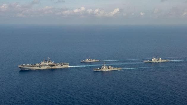 File photo: (L-R) Amphibious assault ship USS America, Royal Australian Navy helicopter frigate HMAS Parramatta, guided-missile destroyer USS Barry and guided-missile cruiser USS Bunker Hill conduct officer of the watch manoeuvres in the South China Sea, in this April 18, 2020 handout photo.(via REUTERS)