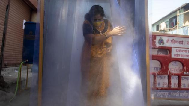 A resident walks out of a sanitization tunnel at Jijamata Nagar in Worli, Mumbai. With cases rising in Mumbai and Pune, the state is yet to take a call on the Centre’s notification allowing neighbourhood shops to open. (Aalok Soni / HT Photo) A resident walks out of a sanitization tunnel at Jijamata Nagar in Worli, Mumbai. With cases rising in Mumbai and Pune, the state is yet to take a call on the Centre’s notification allowing neighbourhood shops to open. (Aalok Soni / HT Photo)