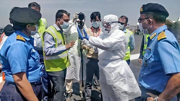 Medical team members from the Navy, wearing protective gear, brief airport officials before the evacuation of Indian nationals from Iran and their arrival in India, at Chhatrapati Shivaji International Airport in Mumbai on March 13, 2020. (AFP) Medical team members from the Navy, wearing protective gear, brief airport officials before the evacuation of Indian nationals from Iran and their arrival in India, at Chhatrapati Shivaji International Airport in Mumbai on March 13, 2020. (AFP)
