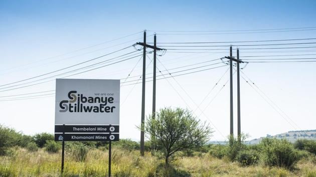A sign directs to the Sibanye-Stillwater Thembelani and Khomanani platinum mines, operated by Sibanye Gold Ltd., at the roadside in Rustenburg, South Africa, on Wednesday, April 22, 2020. South Africa allowed mining companies to resume operations at half their normal capacity as the government takes its first steps to ease a nationwide coronavirus lockdown. (Bloomberg) A sign directs to the Sibanye-Stillwater Thembelani and Khomanani platinum mines, operated by Sibanye Gold Ltd., at the roadside in Rustenburg, South Africa, on Wednesday, April 22, 2020. South Africa allowed mining companies to resume operations at half their normal capacity as the government takes its first steps to ease a nationwide coronavirus lockdown. (Bloomberg)