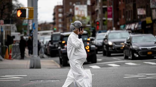 A pregnant woman wearing a hazmat suit and a mask walks in the streets in the Elmhurst neighbourhood of Queens on April 27, 2020 in New York City. (AFP) A pregnant woman wearing a hazmat suit and a mask walks in the streets in the Elmhurst neighbourhood of Queens on April 27, 2020 in New York City. (AFP)