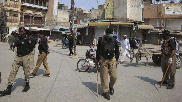 Police officers patrol a market during Covid-19 lockdown, in Pakistan’s Peshawar. (AP Photo) Police officers patrol a market during Covid-19 lockdown, in Pakistan’s Peshawar. (AP Photo)
