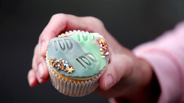 A cupcake is pictured after being given to local residents from the family of army veteran Captain Tom Moore on his 100th birthday in Marston Moretaine, Britain, April 30. Since completing his 100 laps - breaking both his initial 1,000 pound target and then the Guinness world record for a charity walk - Moore has received over 125,000 birthday cards. (Peter Cziborra / REUTERS) A cupcake is pictured after being given to local residents from the family of army veteran Captain Tom Moore on his 100th birthday in Marston Moretaine, Britain, April 30. Since completing his 100 laps - breaking both his initial 1,000 pound target and then the Guinness world record for a charity walk - Moore has received over 125,000 birthday cards. (Peter Cziborra / REUTERS)