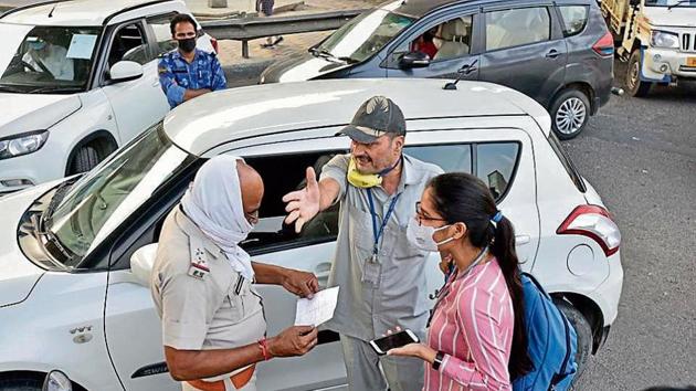 A policeman checks the curfew pass of a commuter at the Delhi-Faridabad border. Faridabad on Wednesday shut its border with Delhi to insulate itself from Covid-19 cases. A policeman checks the curfew pass of a commuter at the Delhi-Faridabad border. Faridabad on Wednesday shut its border with Delhi to insulate itself from Covid-19 cases.