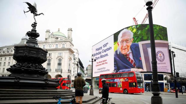 A birthday message for Captain Tom Moore is displayed on the advertising boards in Piccadilly Circus in London on April 30. (Tolga Akmen / AFP) A birthday message for Captain Tom Moore is displayed on the advertising boards in Piccadilly Circus in London on April 30. (Tolga Akmen / AFP)