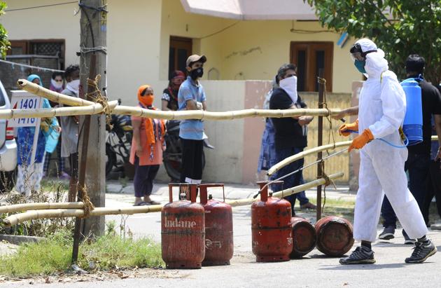 A health worker sanitising LPG cylinders before delivery to Sector 30, Chandigarh, which is one of the city’s major Covid-19 hotspots, on Thursday. (ANIL DAYAl/HT) A health worker sanitising LPG cylinders before delivery to Sector 30, Chandigarh, which is one of the city’s major Covid-19 hotspots, on Thursday. (ANIL DAYAl/HT)