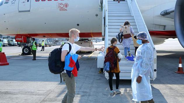 An airport staff wears a protective suit while checking the boarding pass of German passengers before take-off as GMR led Hyderabad International Airport is handling a special relief flight of Air India to evacuate German nationals stranded amid coronavirus pandemic, in Hyderabad. (ANI) An airport staff wears a protective suit while checking the boarding pass of German passengers before take-off as GMR led Hyderabad International Airport is handling a special relief flight of Air India to evacuate German nationals stranded amid coronavirus pandemic, in Hyderabad. (ANI)