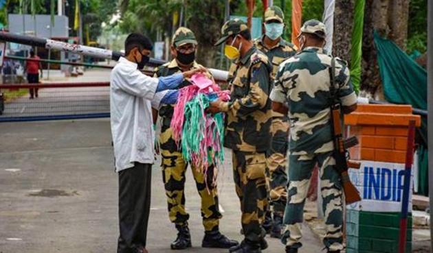 South Tripura: Security personnel distribute masks to villagers during the nationwide lockdown, in wake of the coronavirus pandemic, at Twichama village of Sabroom in South Tripura, Tuesday, April 21, 2020. (PTI) South Tripura: Security personnel distribute masks to villagers during the nationwide lockdown, in wake of the coronavirus pandemic, at Twichama village of Sabroom in South Tripura, Tuesday, April 21, 2020. (PTI)