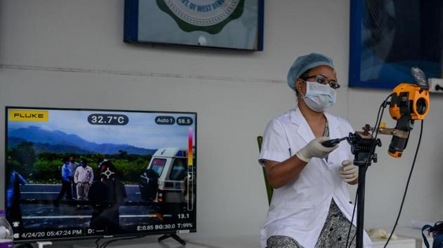 A medical staff uses a thermal scanner at an information collection and awareness desk set up by the West Bengal Health Department of Darjeeling district during a government-imposed nationwide lockdown as a preventive measure against the COVID-19 coronavirus, in Simulbari village on the outskirts of Siliguri. (AFP) A medical staff uses a thermal scanner at an information collection and awareness desk set up by the West Bengal Health Department of Darjeeling district during a government-imposed nationwide lockdown as a preventive measure against the COVID-19 coronavirus, in Simulbari village on the outskirts of Siliguri. (AFP)