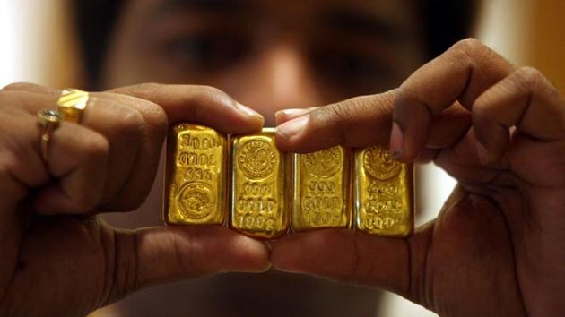 A salesman displays gold bars inside a jewellery shop on the occasion of the Akshaya Tritiya festival in the southern city of Hyderabad. (Reuters File Photo) A salesman displays gold bars inside a jewellery shop on the occasion of the Akshaya Tritiya festival in the southern city of Hyderabad. (Reuters File Photo)